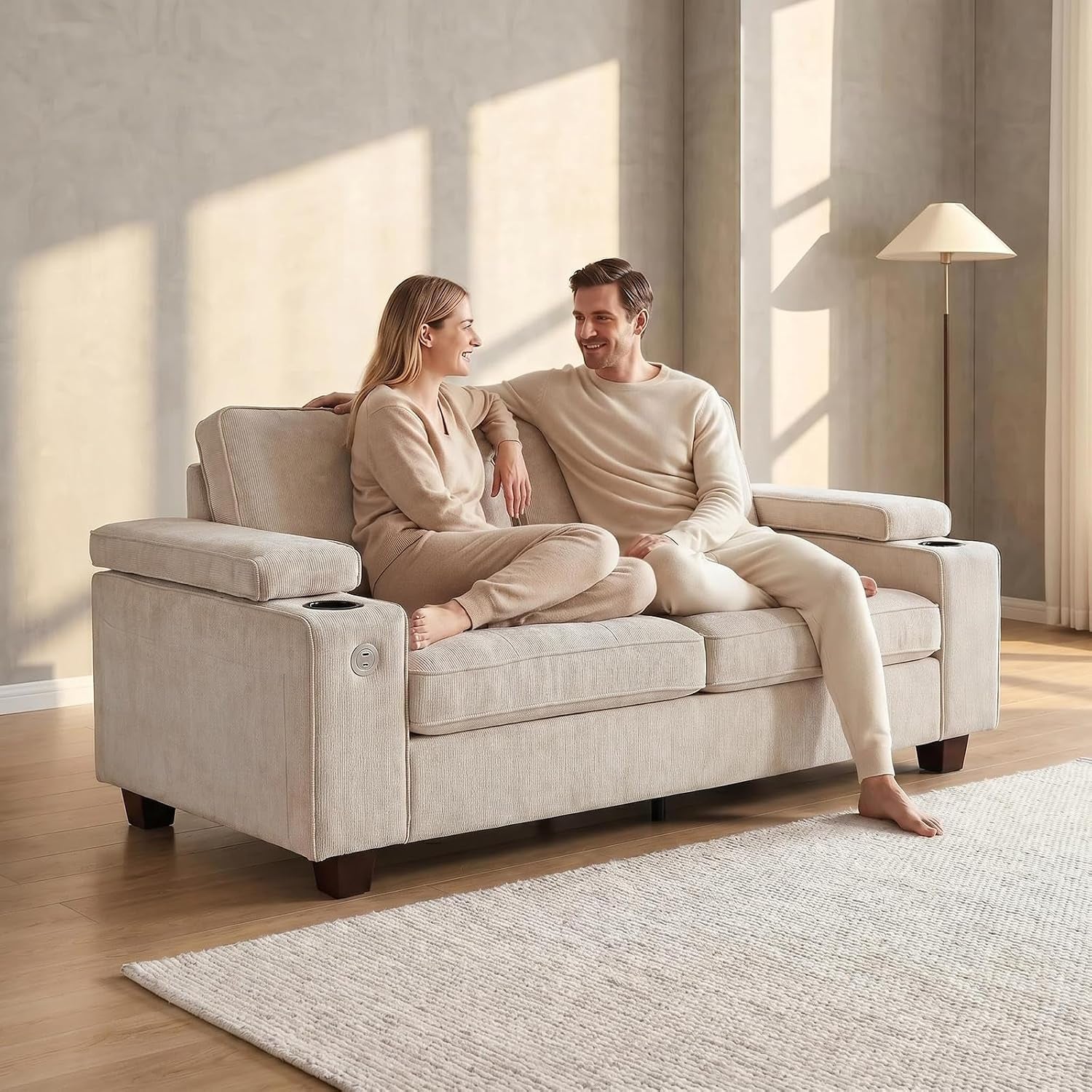 Beige chenille 73-inch loveseat angled front view with two people sitting in a sunlit living room