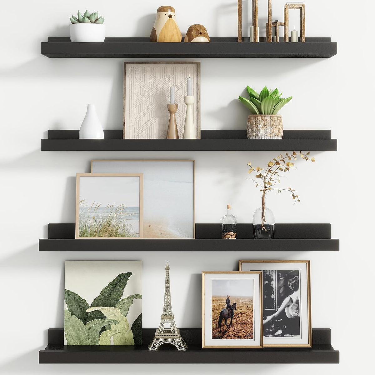Three black floating ledges shown with framed art, a small Eiffel Tower ornament and decorative bottles