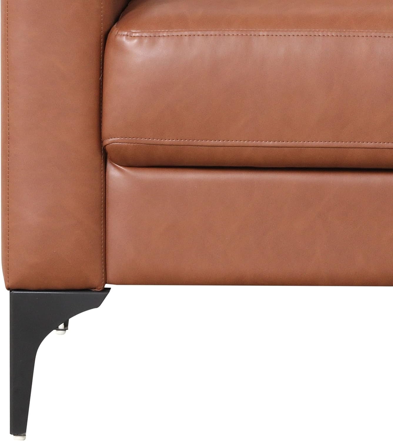 Close-up of sofa seat edge and slender black metal leg with adjustable glide under tan upholstery.