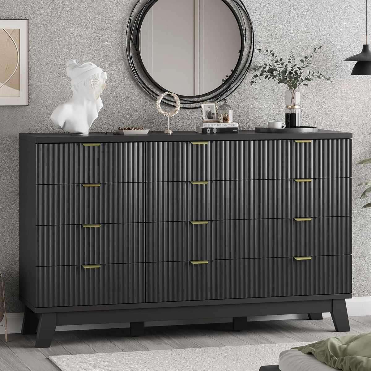 Cropped frontal view of a wider black dresser showing multiple ribbed drawers and gold handles.