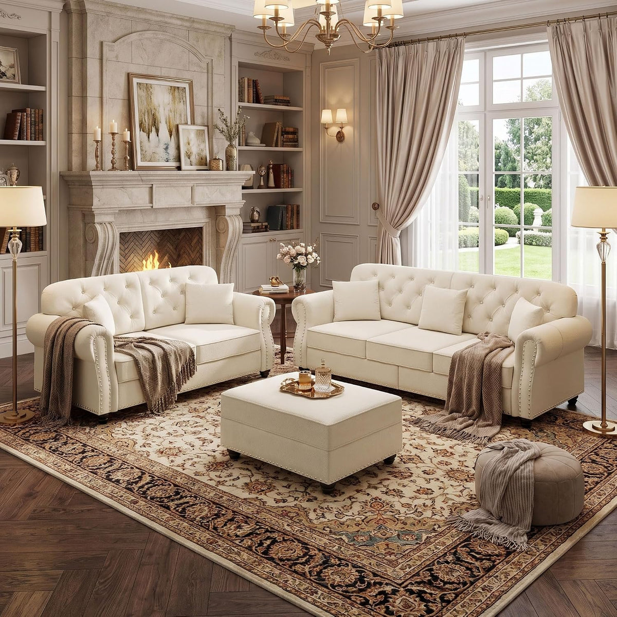 Beige velvet Chesterfield-style sofa and loveseat with coordinating ottoman, angled front view in an elegant living room
