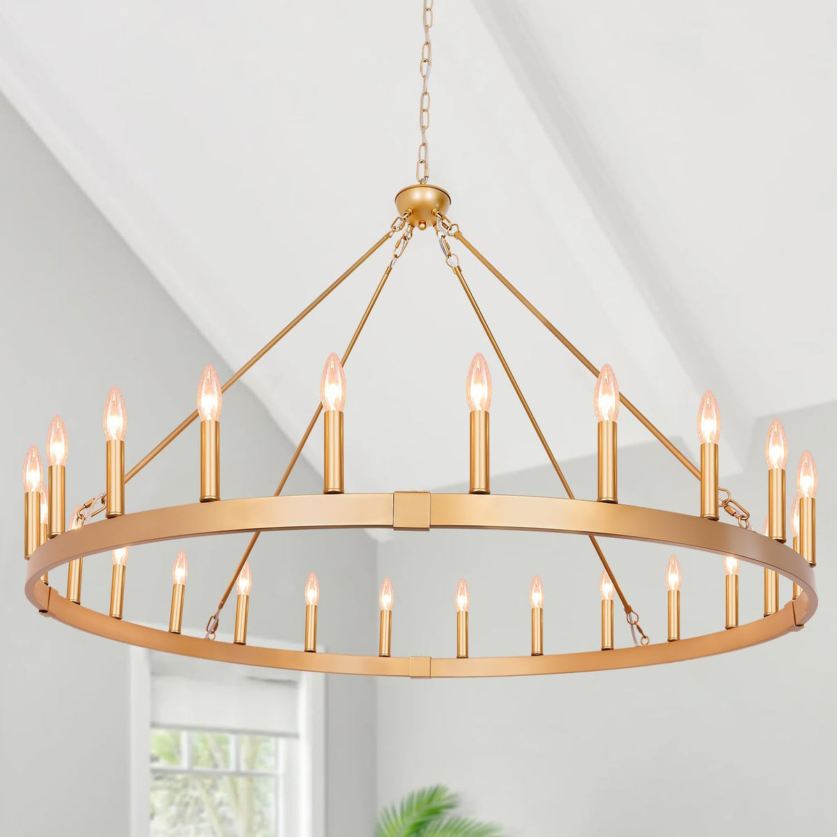Wide crop of a gold circular chandelier suspended from a chain, showing the full outer ring and bulbs