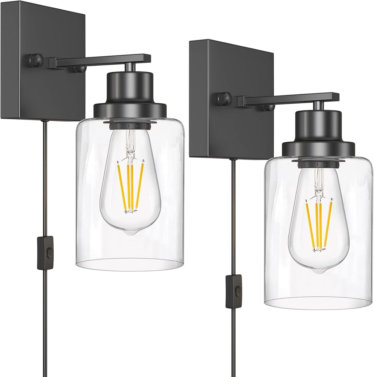 Close-up of two matte black wall-mounted fixtures with clear glass shades and an inline cord switch.