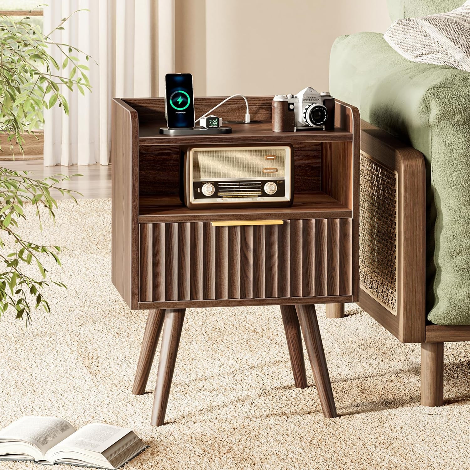 Walnut nightstand in bedroom setting showing open shelf with vintage radio and fluted drawer front