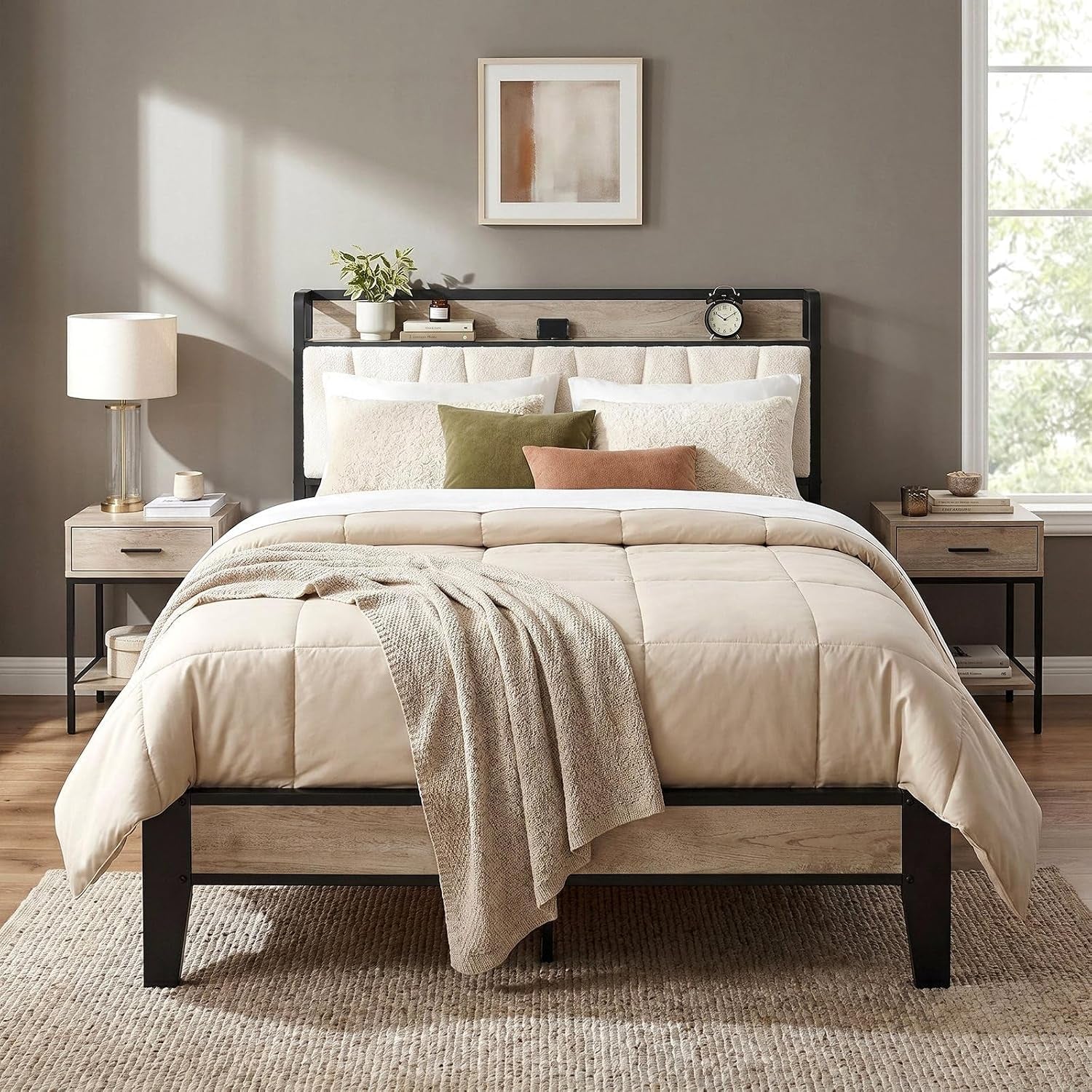 Front view of bed with light wood headboard, cream upholstered panel, beige comforter and matching nightstands.