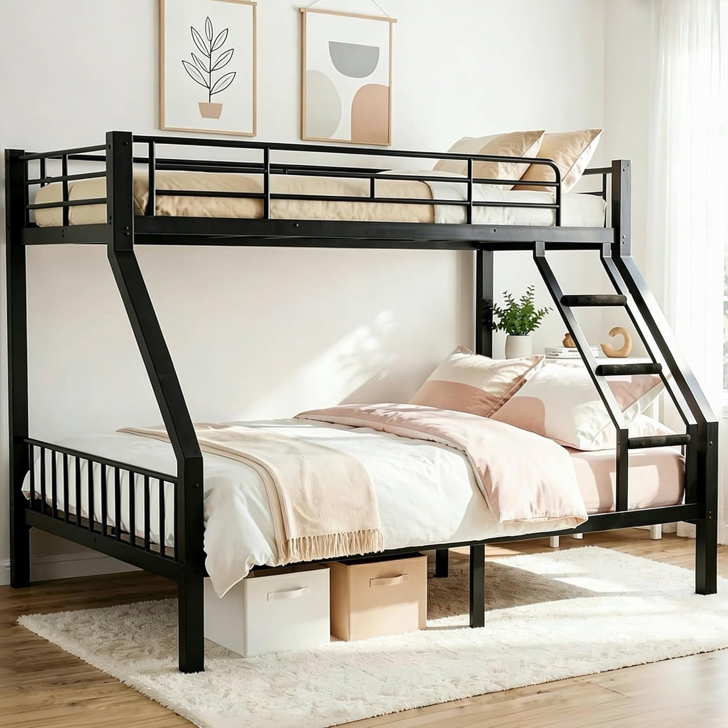 Black metal Twin XL over Queen bunk bed in a bright bedroom with angled ladder, pale pink bedding and storage boxes
