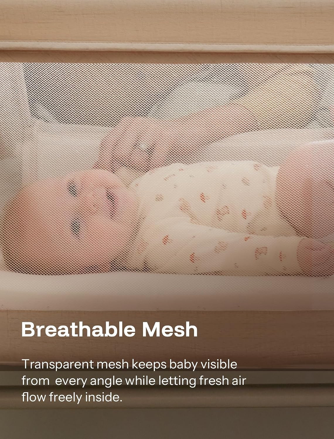 Close-up through breathable mesh showing a baby lying on a mattress inside the bassinet.