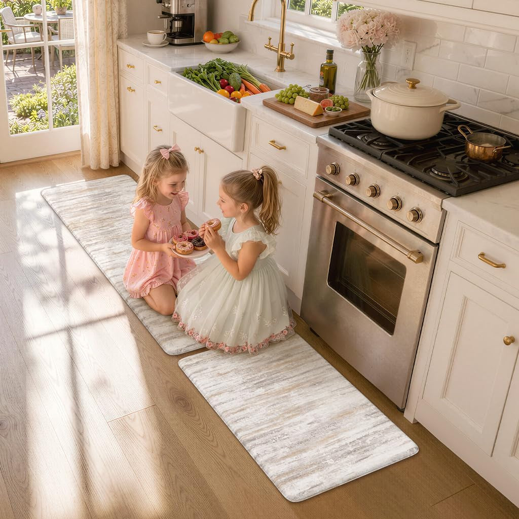 Two young girls sitting on the kitchen runner playing and sharing donuts beside the stove