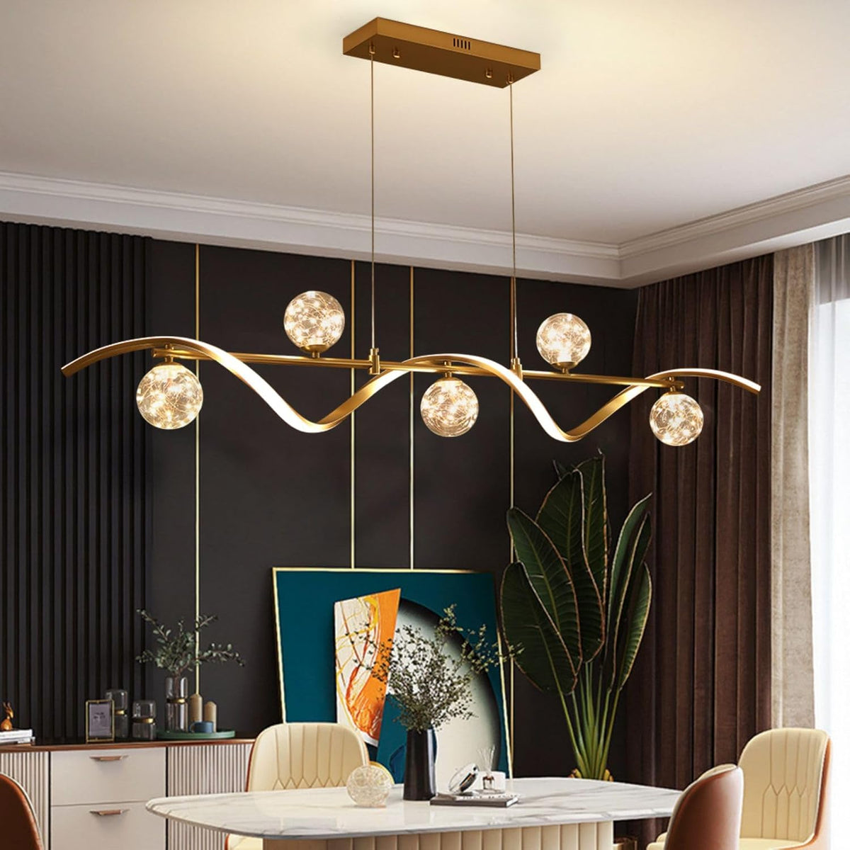 Close-up of gold metal wave arm and clear glass globe shade showing internal LED string lights