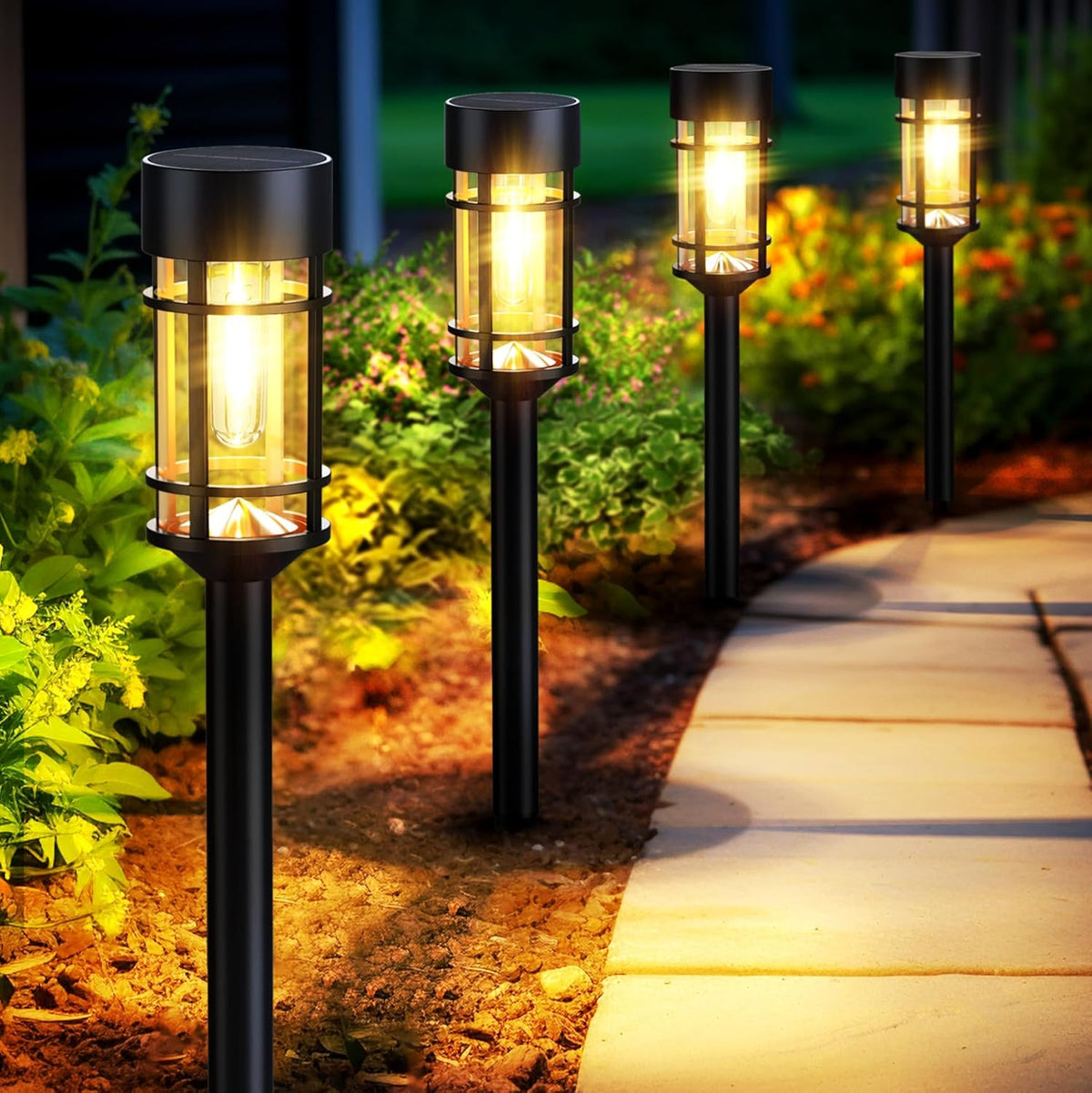 Black solar pathway lights lining a garden path at dusk, angled side view with warm illumination