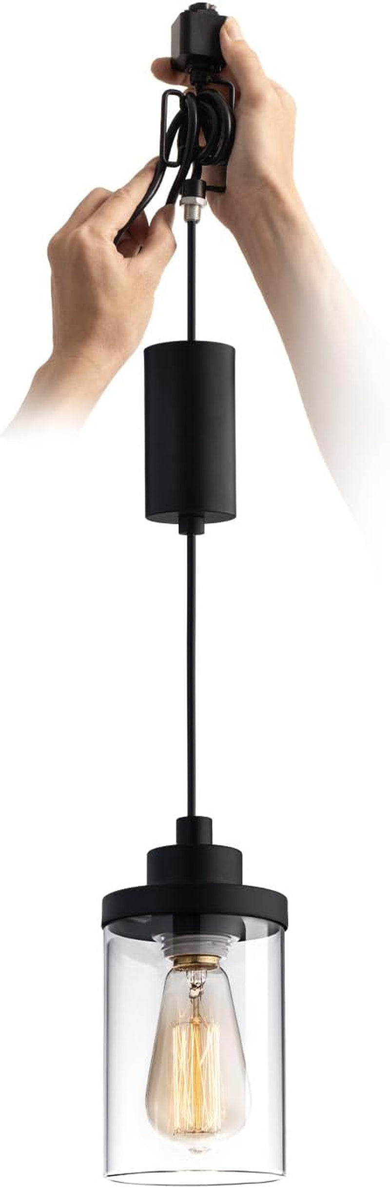 Hands adjusting wiring on a black pendant with clear glass shade and visible filament bulb