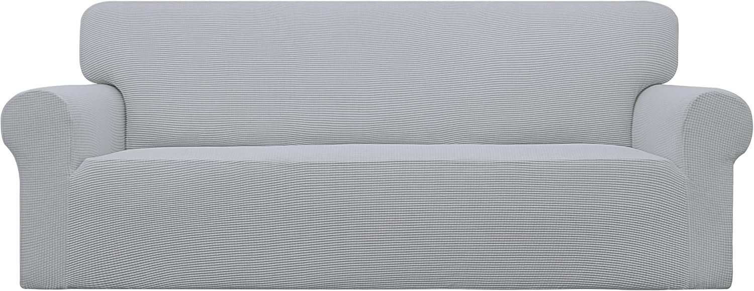 Front view of loveseat with a pale gray textured slipcover fitted over arms and seat
