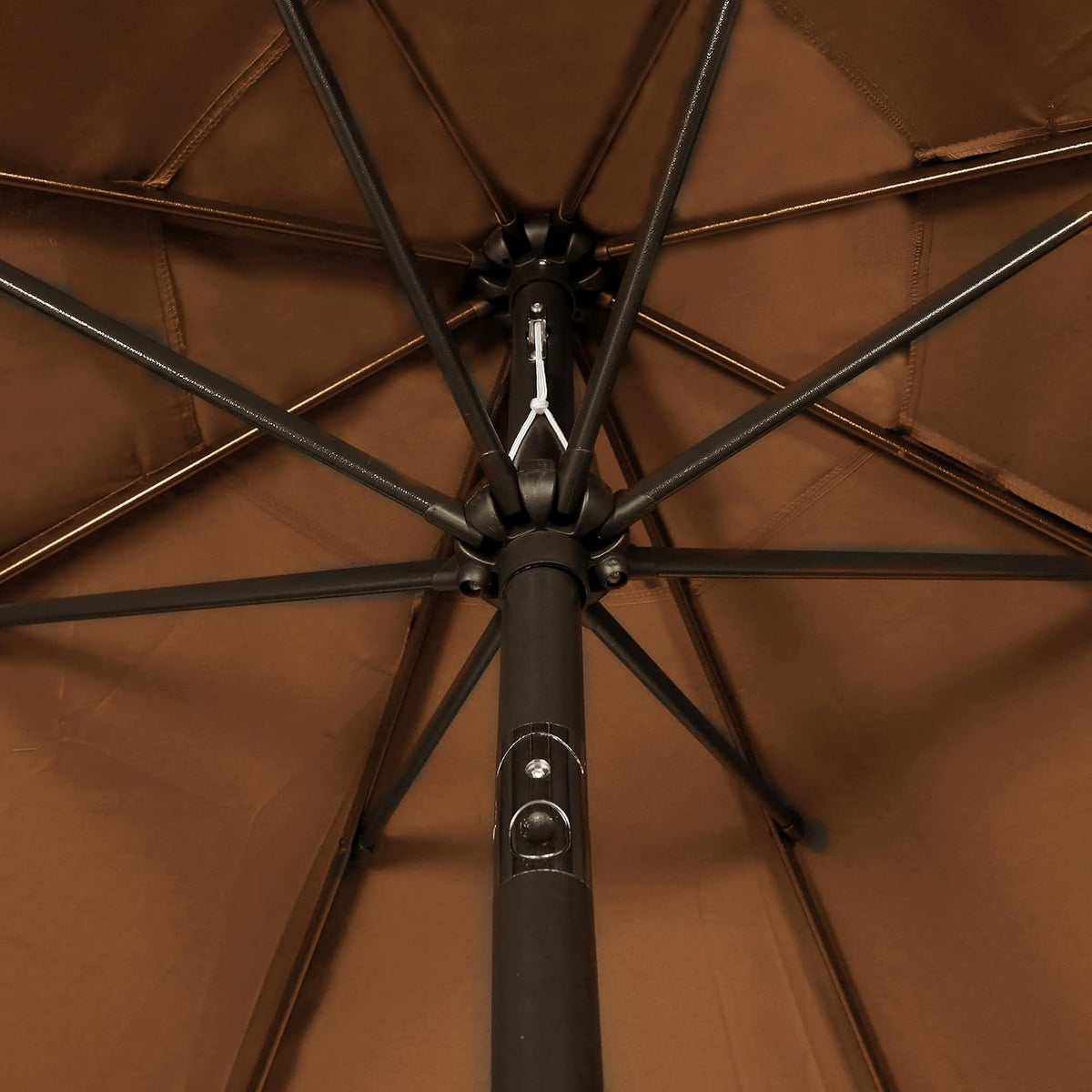 Underside view of brown umbrella showing the eight ribs and central hub from below