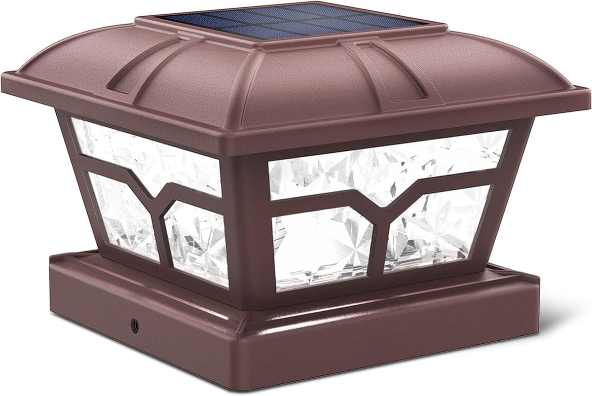 Bronze post cap light with a solar panel on top and clear faceted side panels.