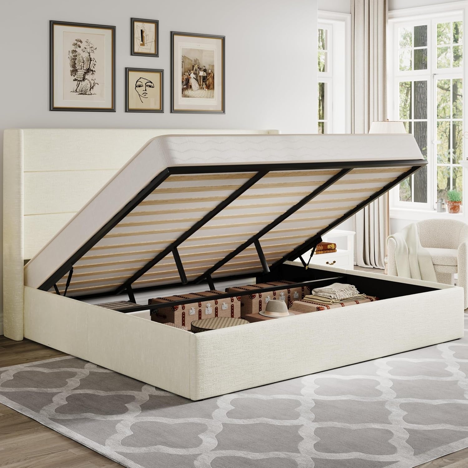 Ivory upholstered storage bed shown gas-lifted with trunk storage revealed, staged in a bright bedroom.