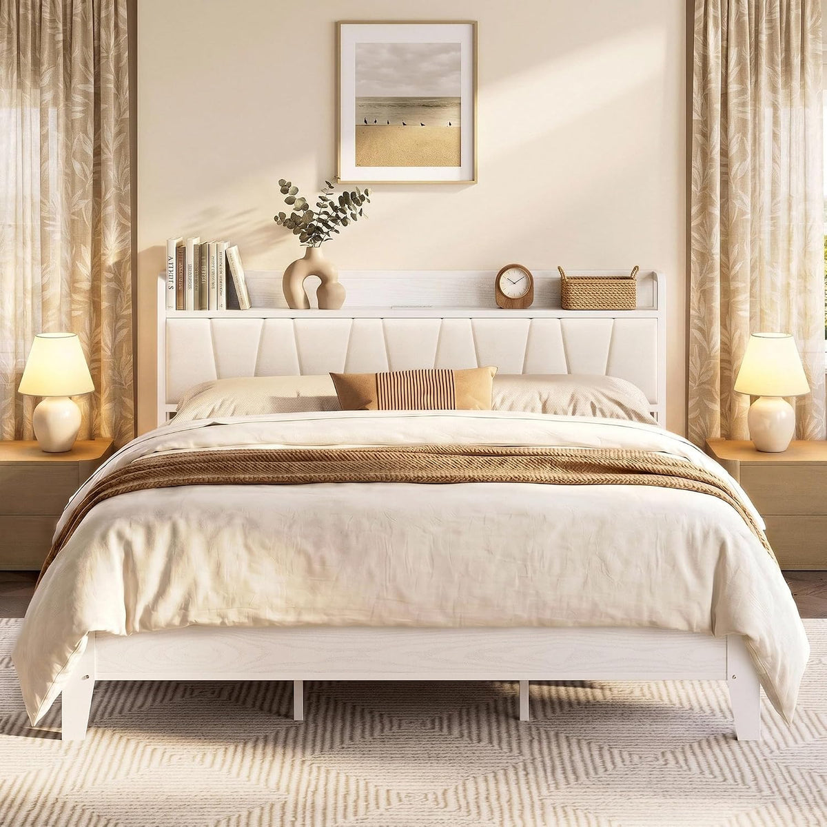 Front view of white bed frame with padded white headboard, light beige bedding and matching nightstands.