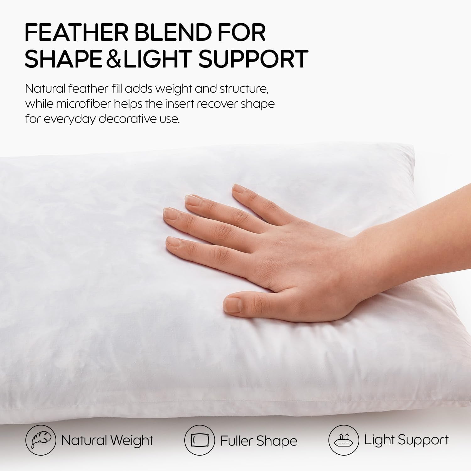 Hand pressing a white pillow insert to show softness and light support, close-up on fabric surface