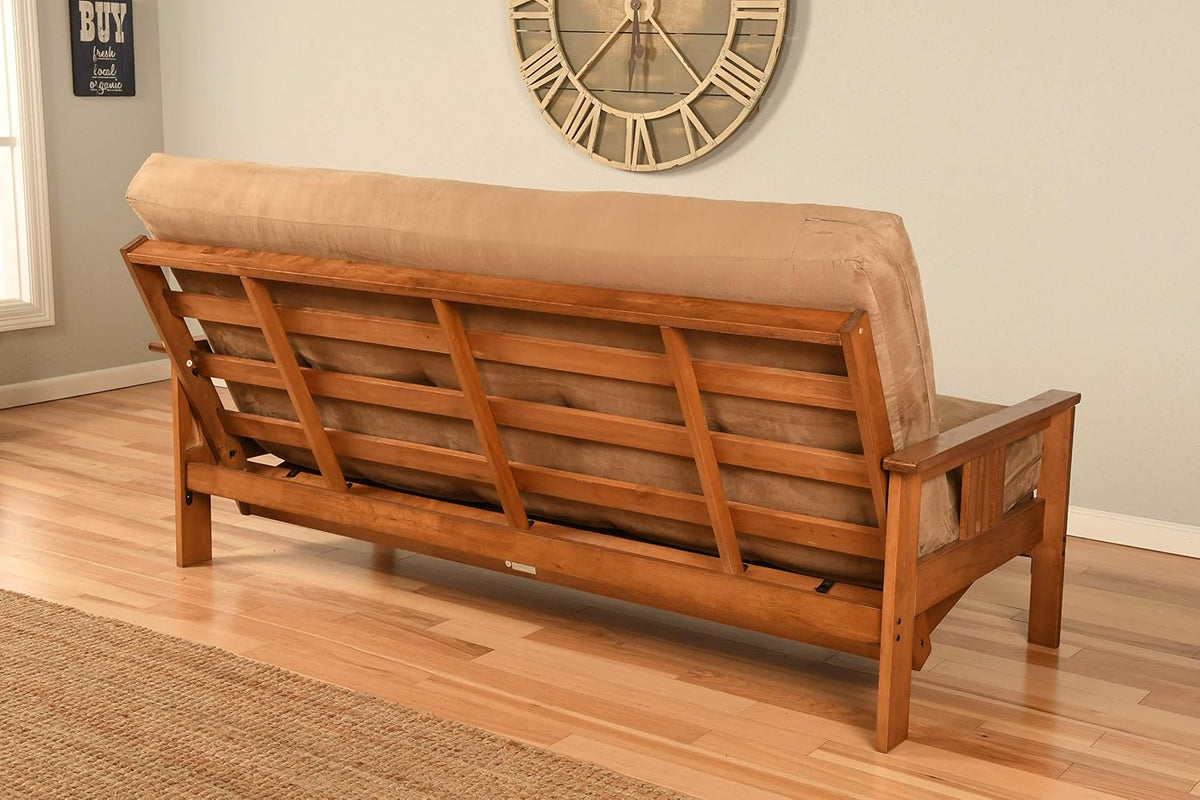 Rear view of futon showing slatted hardwood back and a beige cushion in a living room setting
