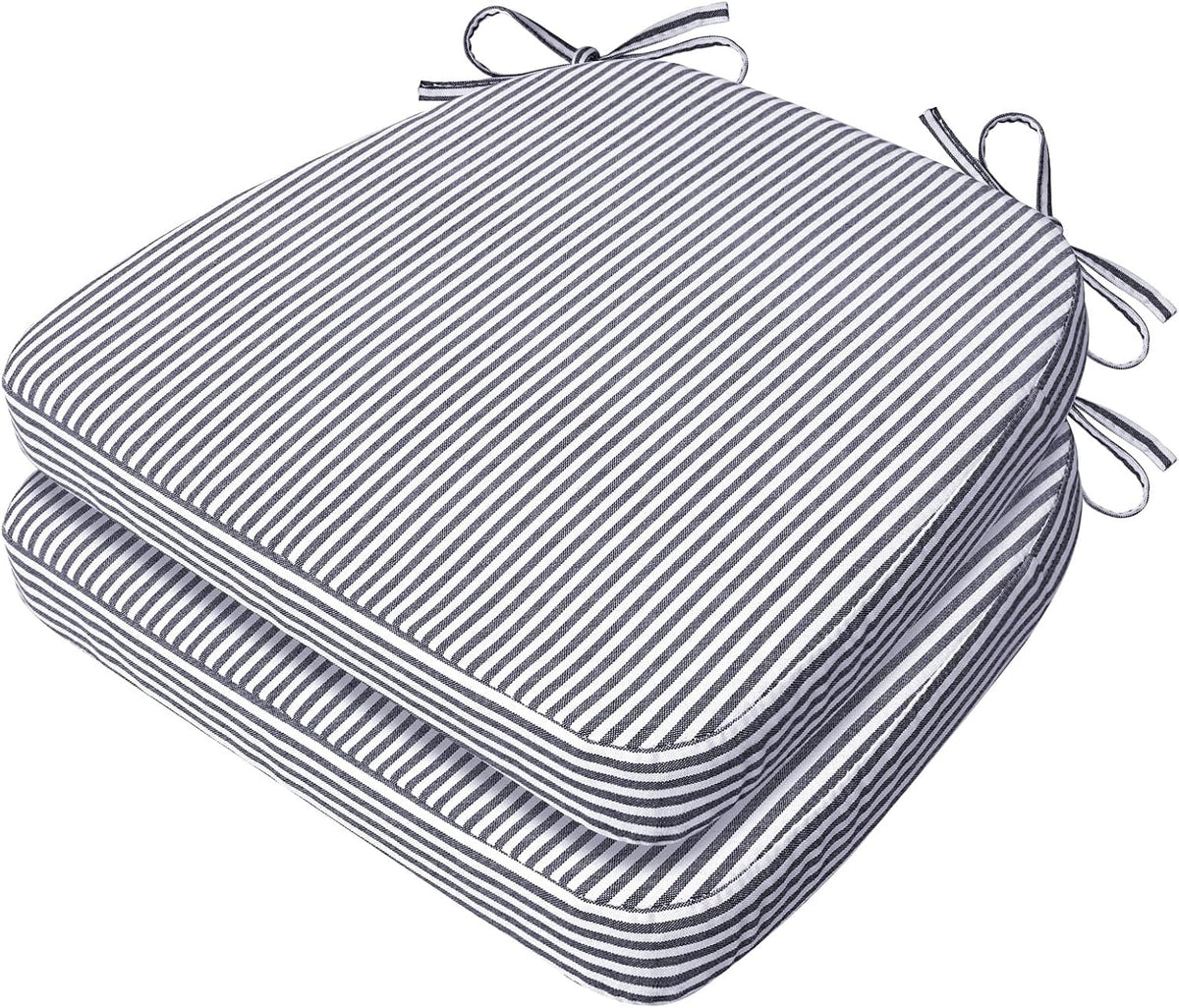 Two stacked D-shaped chair cushions in narrow black-and-white stripes with tied corner strings