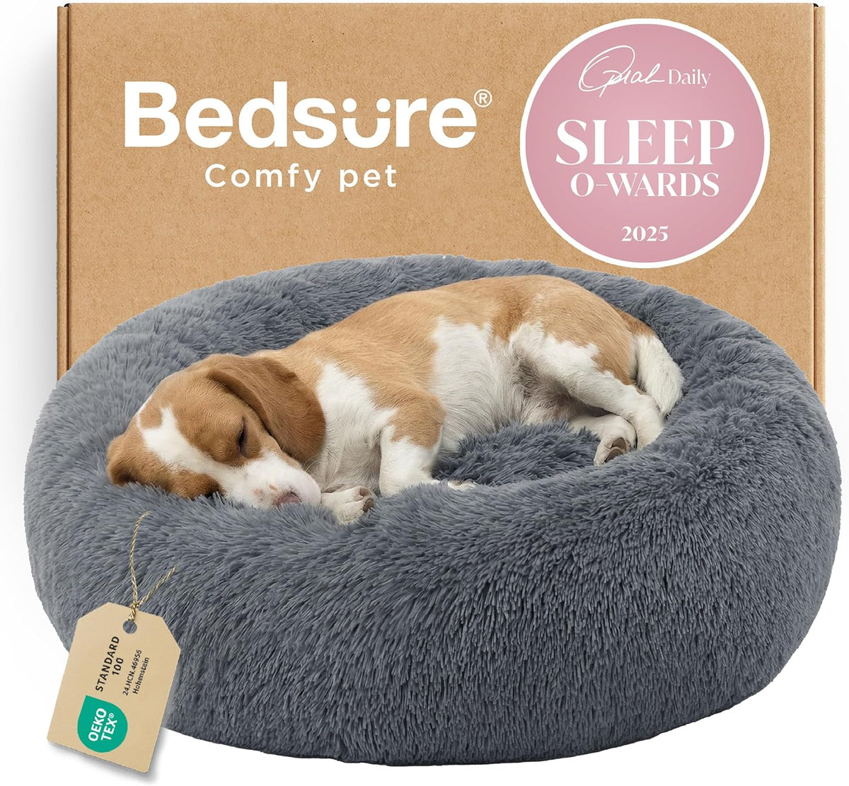 Gray round faux-fur donut bed with a sleeping beagle in front of a cardboard box and tag