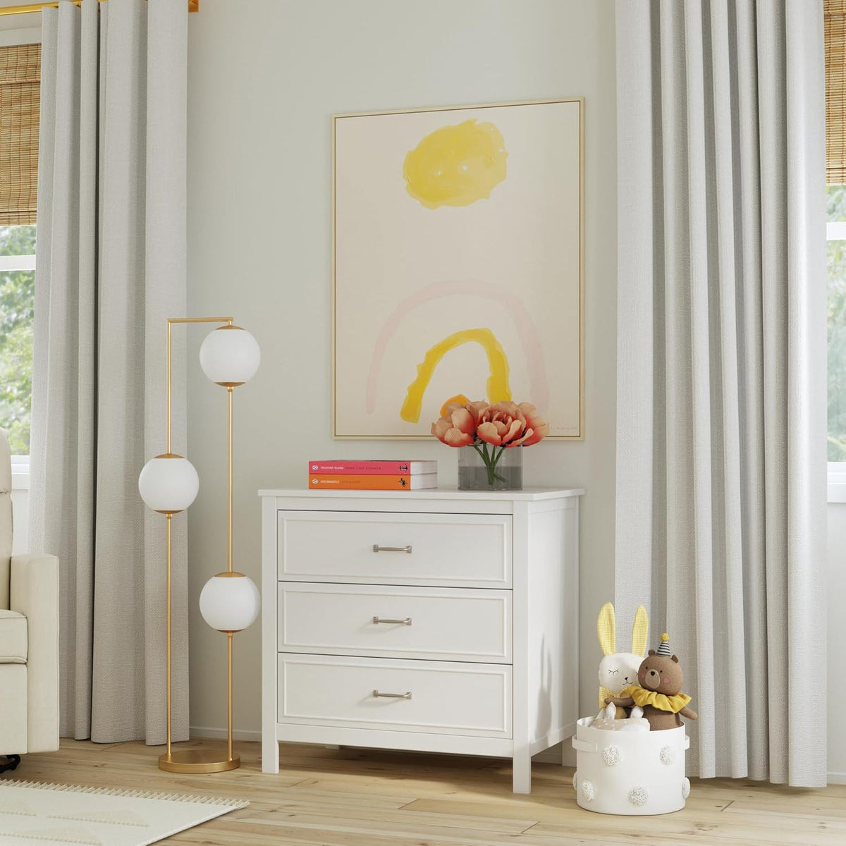 Full nursery scene with white 3-drawer dresser beside curtains and a plush toy basket
