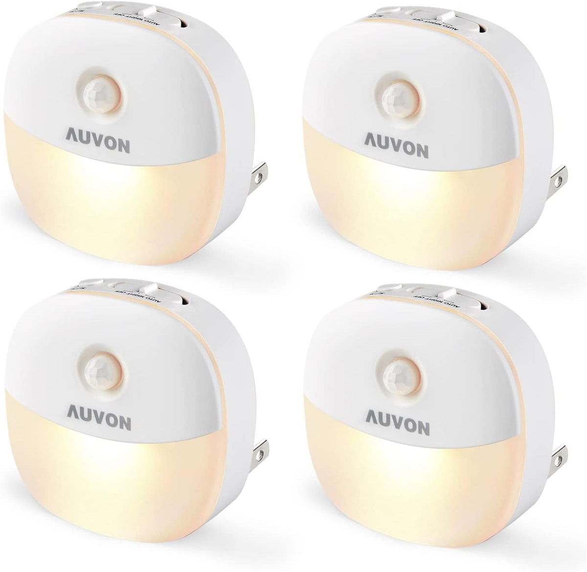 Four white plug-in night lights with warm glowing fronts arranged in a grid.