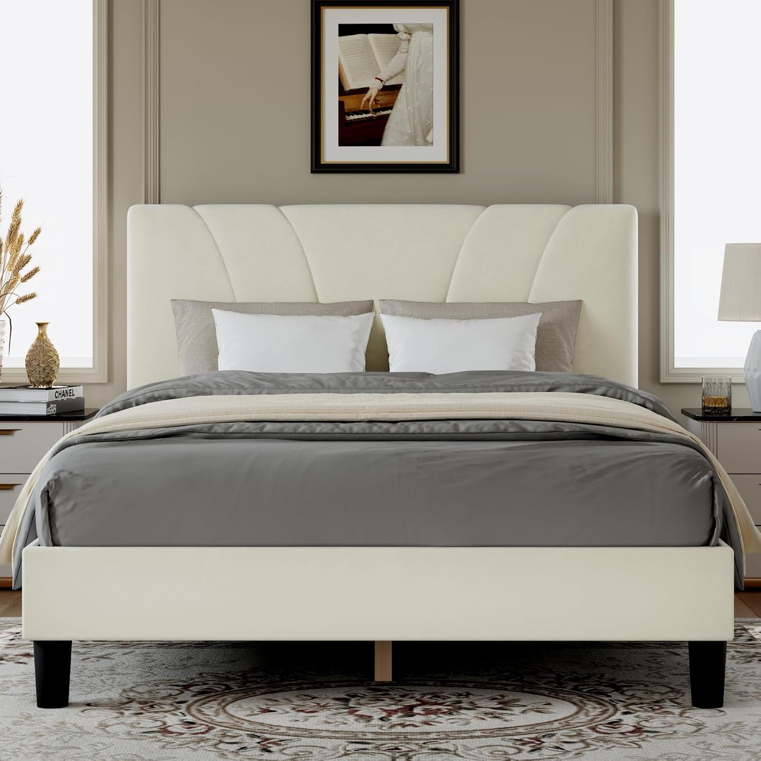 Front bedroom view of an ivory upholstered bed with a fan-pattern headboard and gray bedding.