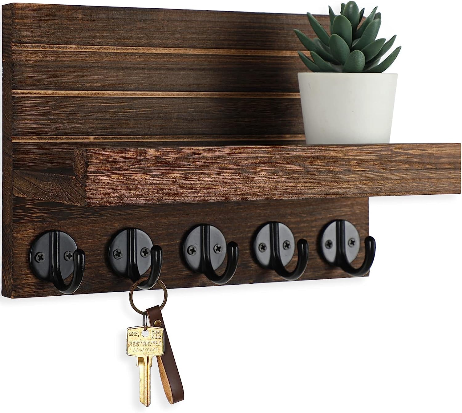 Dark brown key holder with five black hooks, a shelf, potted succulent, and hanging key.