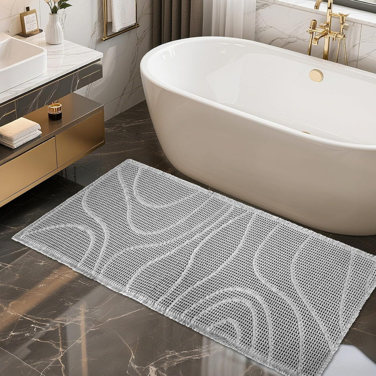Top-down bathroom shot of a light gray textured runner with wavy pattern beside a freestanding tub and gold fixtures