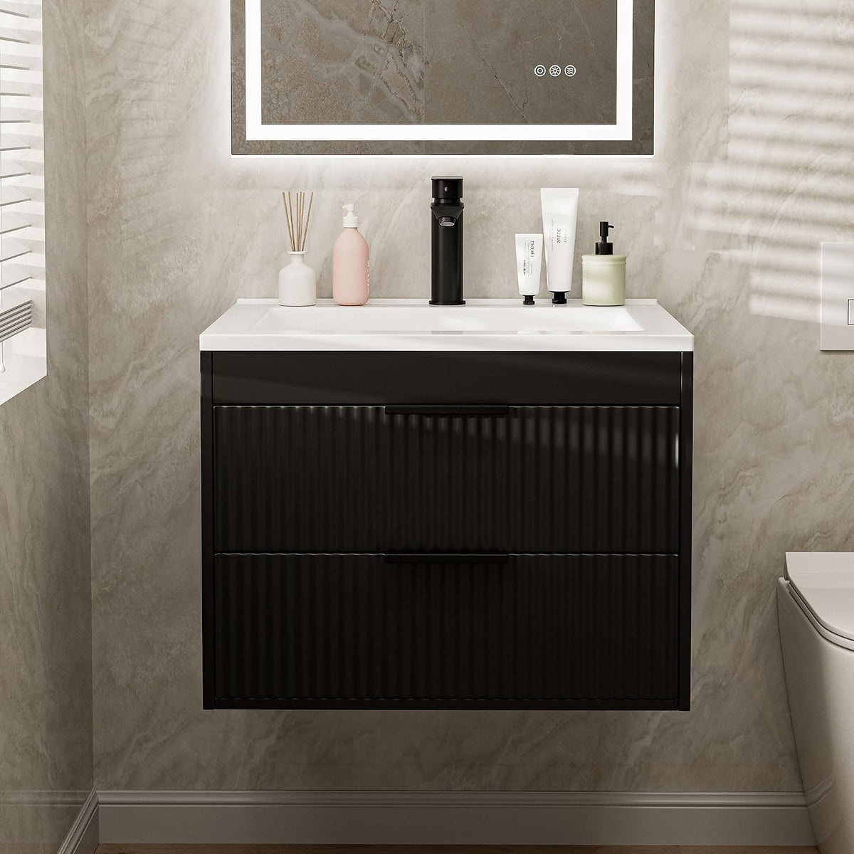 Black floating bathroom vanity with ribbed drawer fronts and white resin basin, straight front view