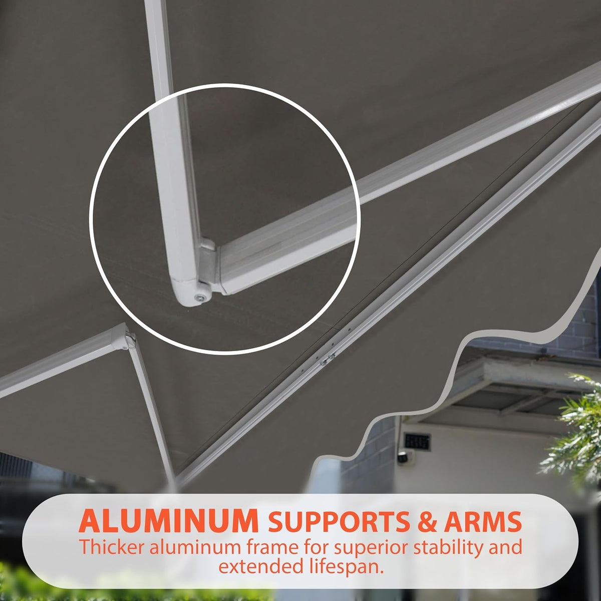 Close-up of a white aluminum awning arm and hinge joint against dark fabric.