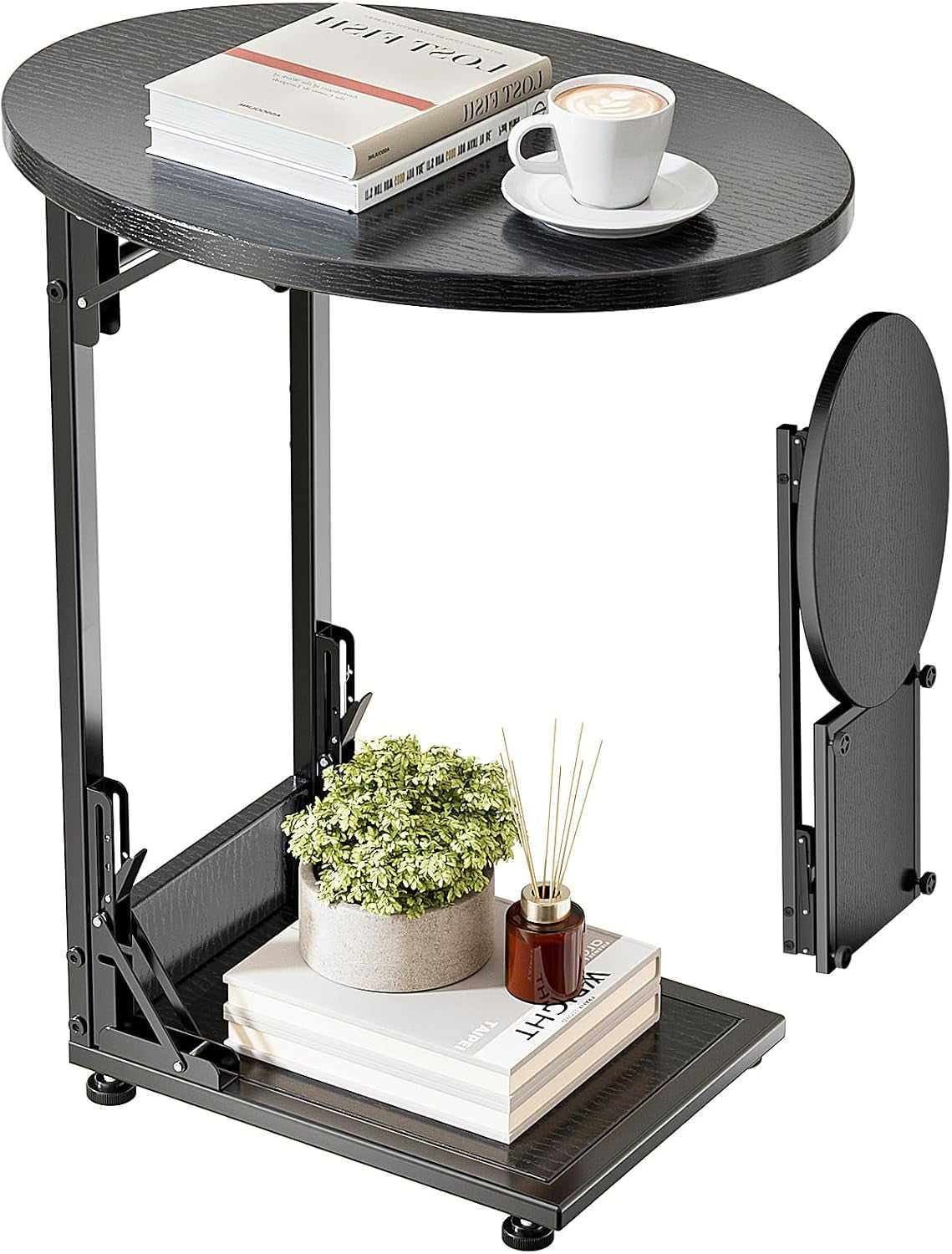 Black C-shaped folding side table with oval top, lower shelf and decorative book, plant, and coffee cup