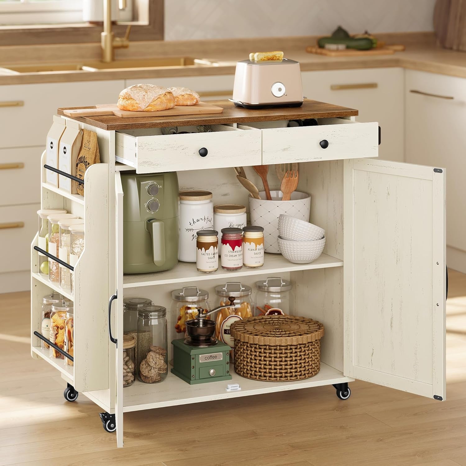 Close view of the island with both drawers open and one cabinet door open showing shelves and stored jars