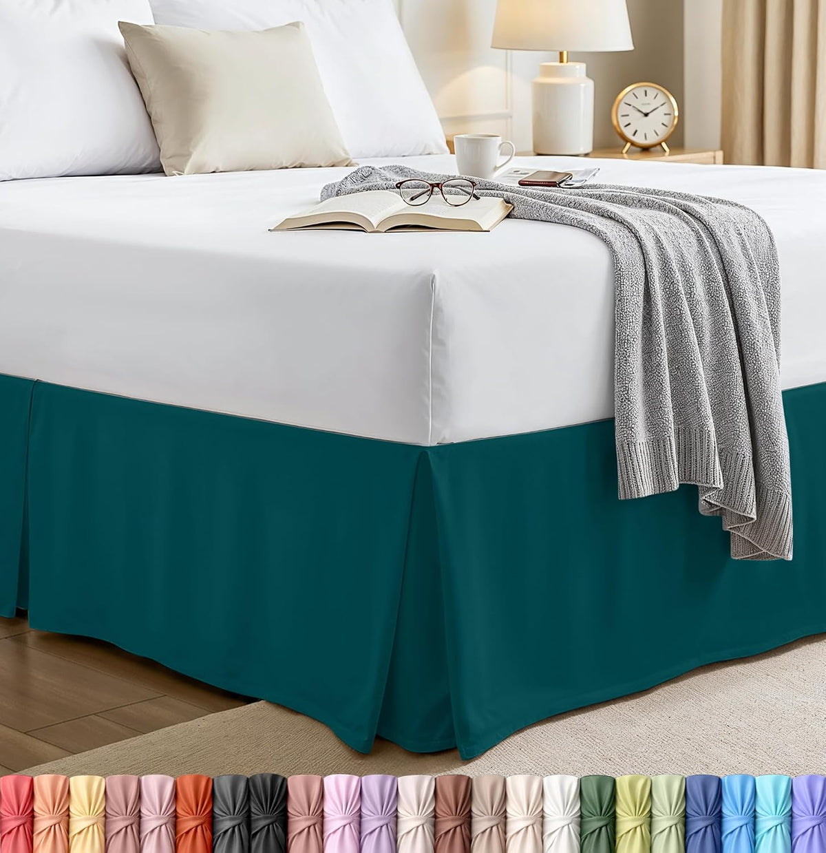 Bedroom corner showing a dark teal pleated bed skirt under a white mattress with a gray throw.