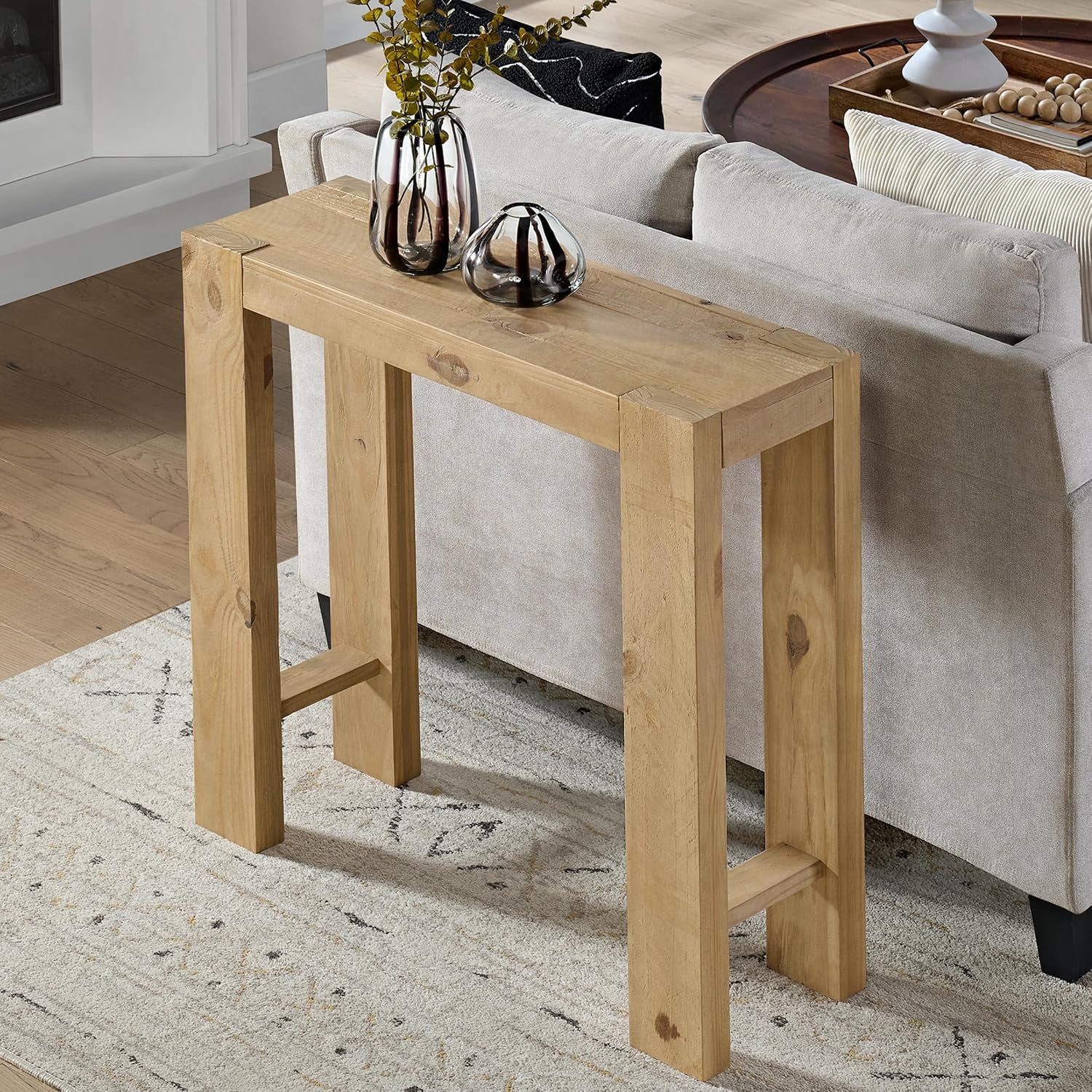 Tighter angled view from above the right end showing the thick tabletop, right leg pair with lower stretcher and rustic