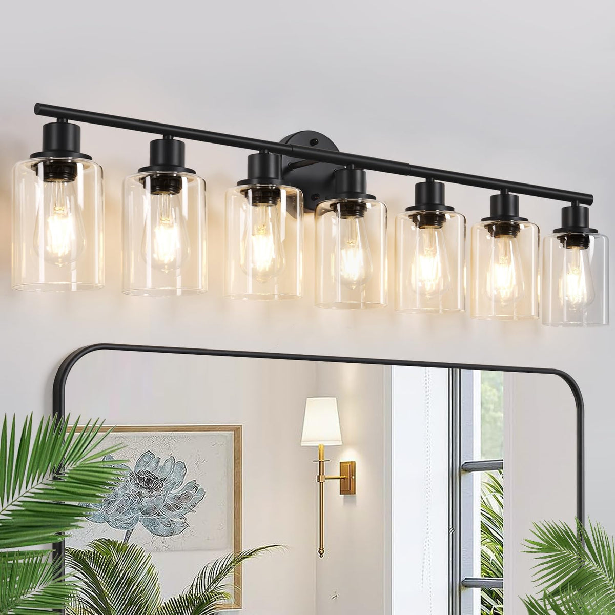 Wide wall-mounted light fixture with six clear glass cylindrical shades on a black bar above a mirror.
