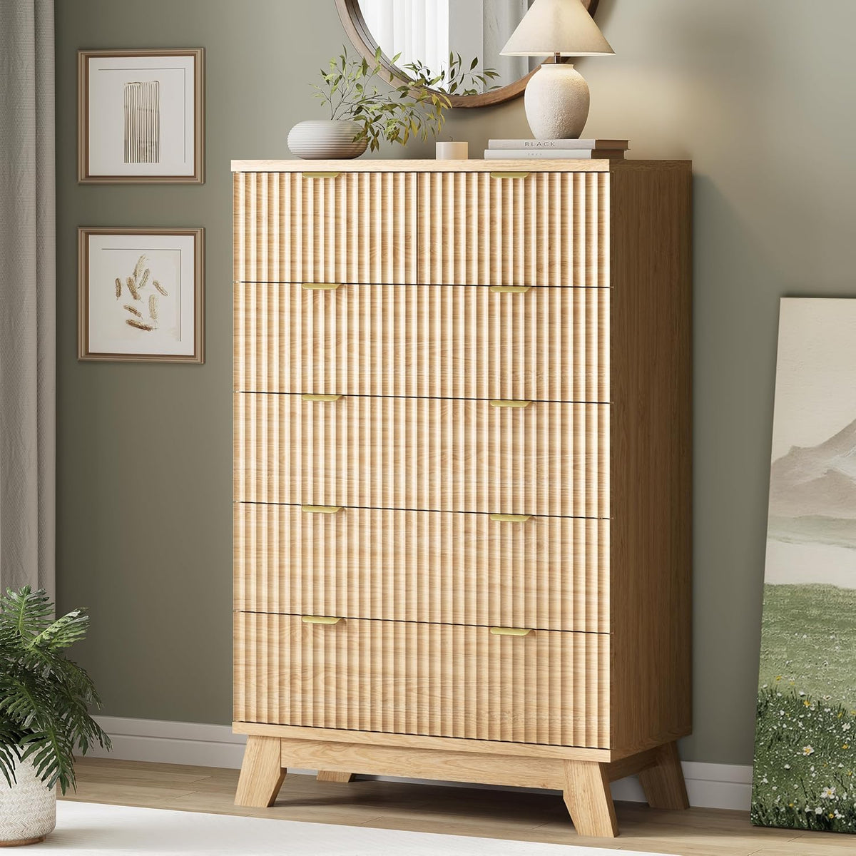 Tall wave-panel chest in light oak with gold handles, styled with mirror, lamp and plant