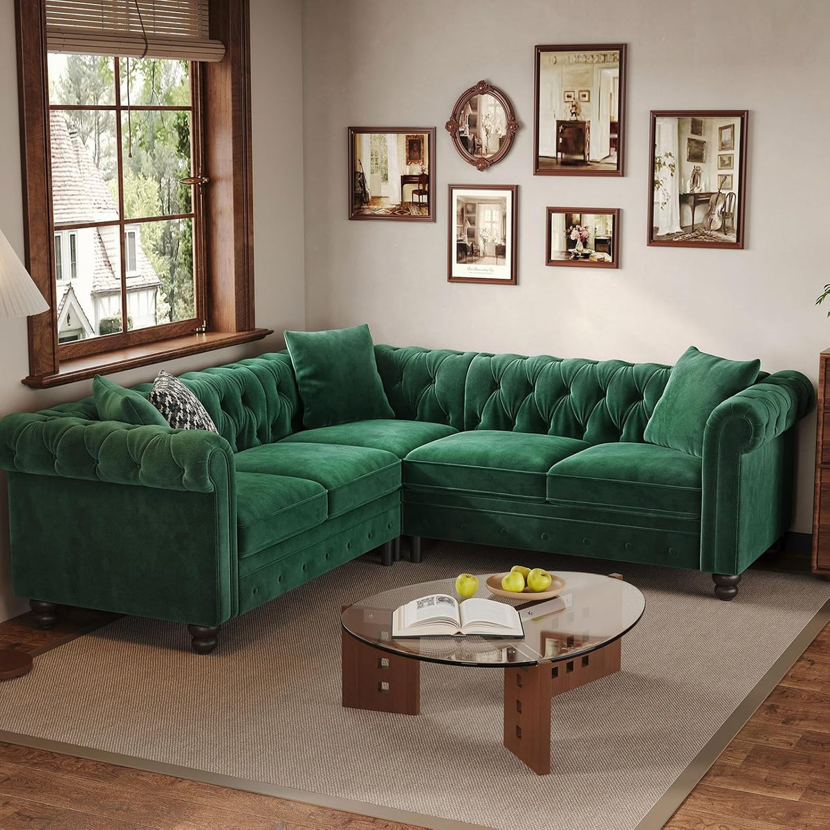 Top-side angle of the green velvet sectional in a living room with patterned throw pillows and round table