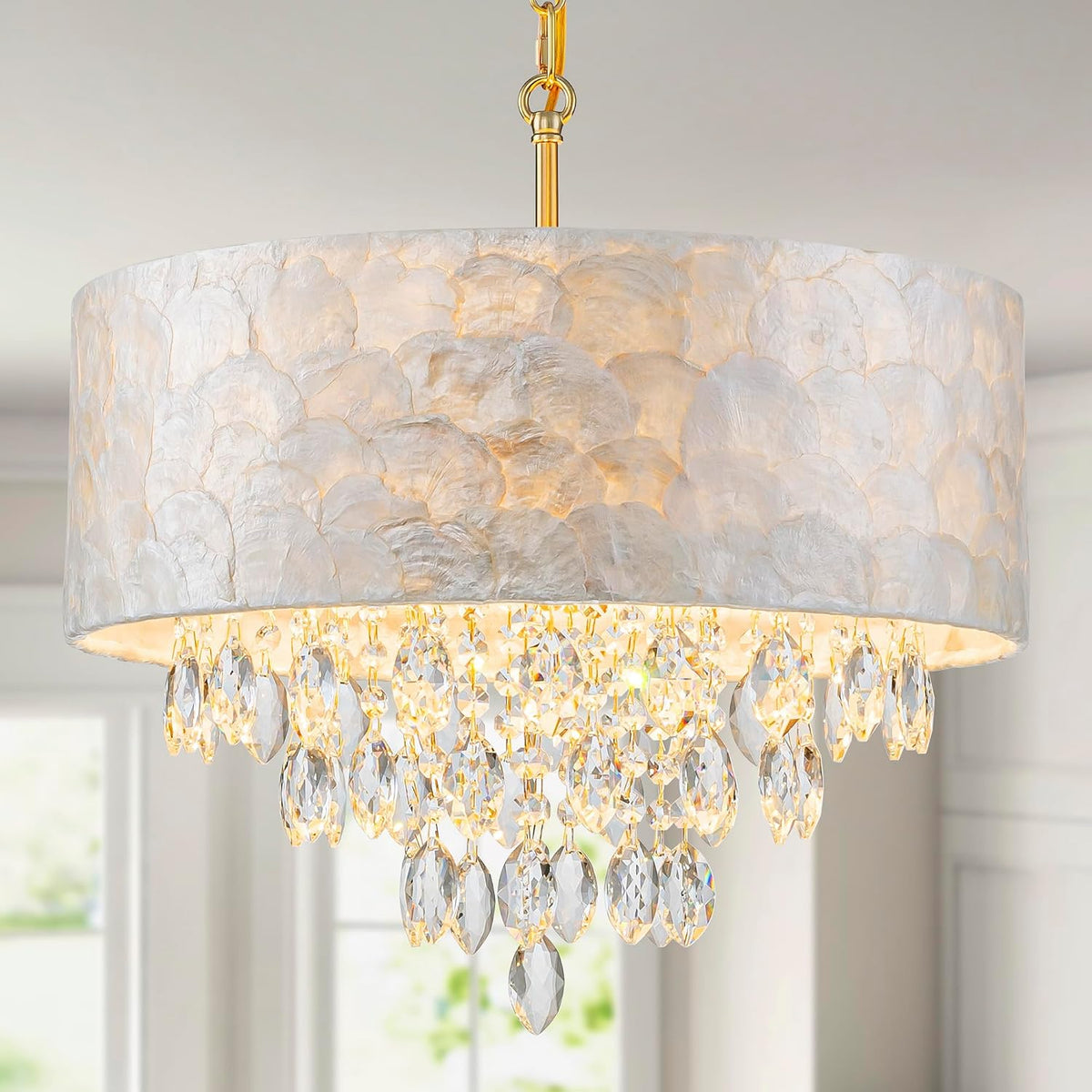Angled view highlighting the scalloped capiz shade texture with crystals hanging inside the illuminated drum.