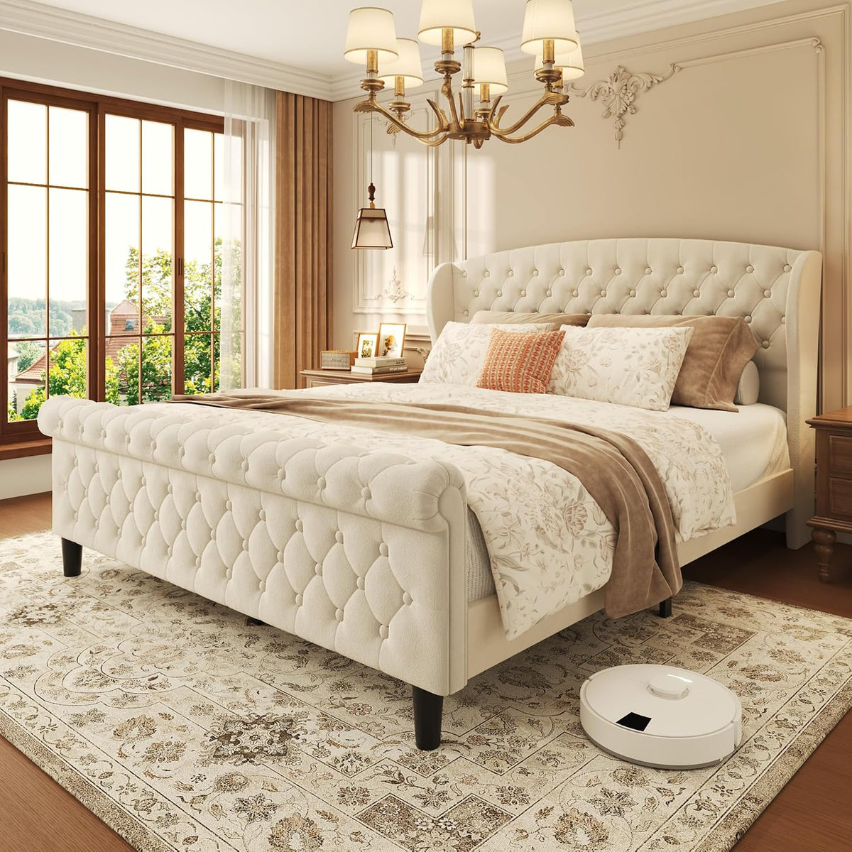 Angled front-left view of a light beige tufted velvet sleigh bed with rolled footboard in a bright bedroom