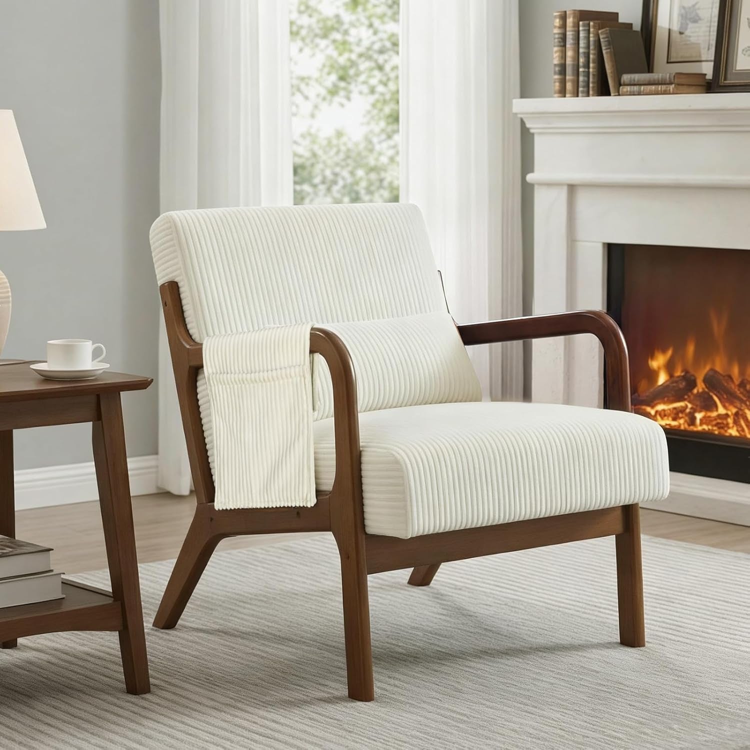 Beige ribbed upholstered accent chair with wooden frame and lumbar pillow near a side table and fireplace.