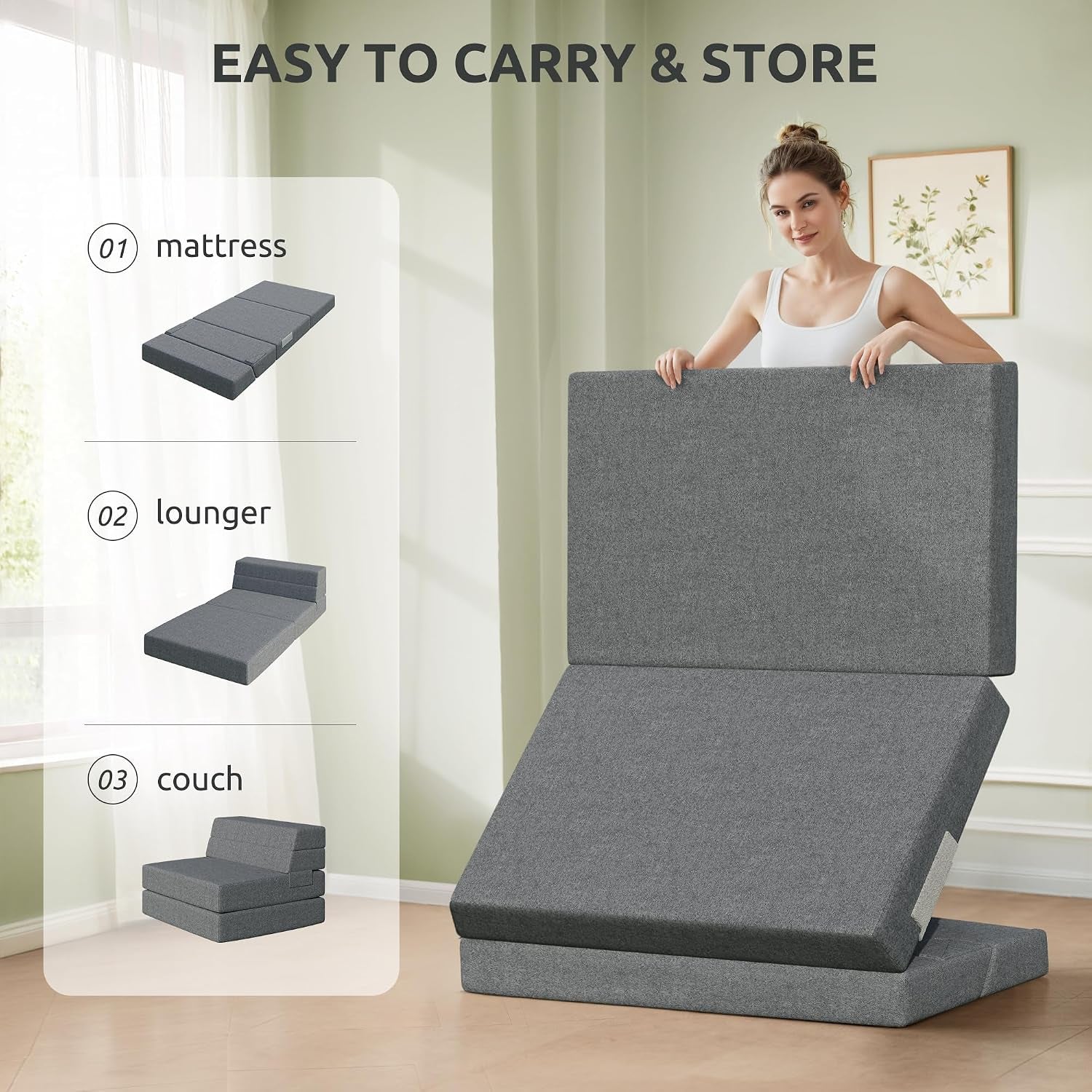 Person holding a folded dark gray tri-fold mattress upright next to a folded cushion base.