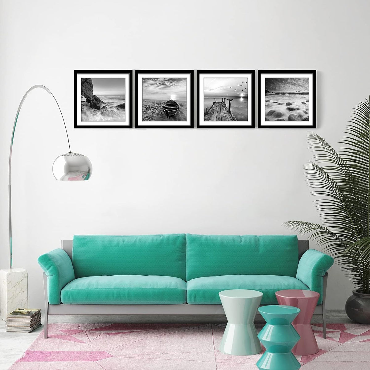 Black-and-white seascape four-panel framed prints mounted in a single row above a teal sofa in a living room setting