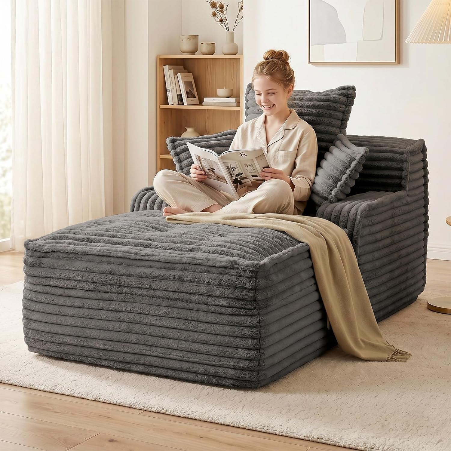 Grey boneless chaise lounge with pillows and deep seat angled front view in a living room
