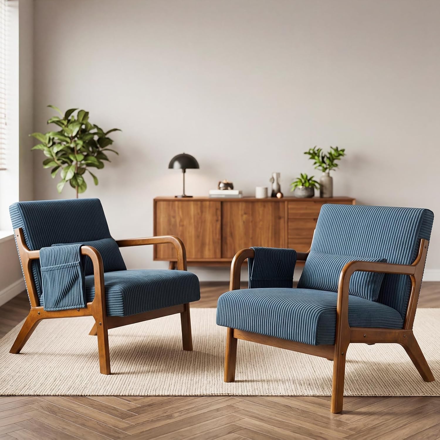 Pair of mid-century wooden-frame accent chairs with blue ribbed upholstery and removable lumbar pillows in a living room.