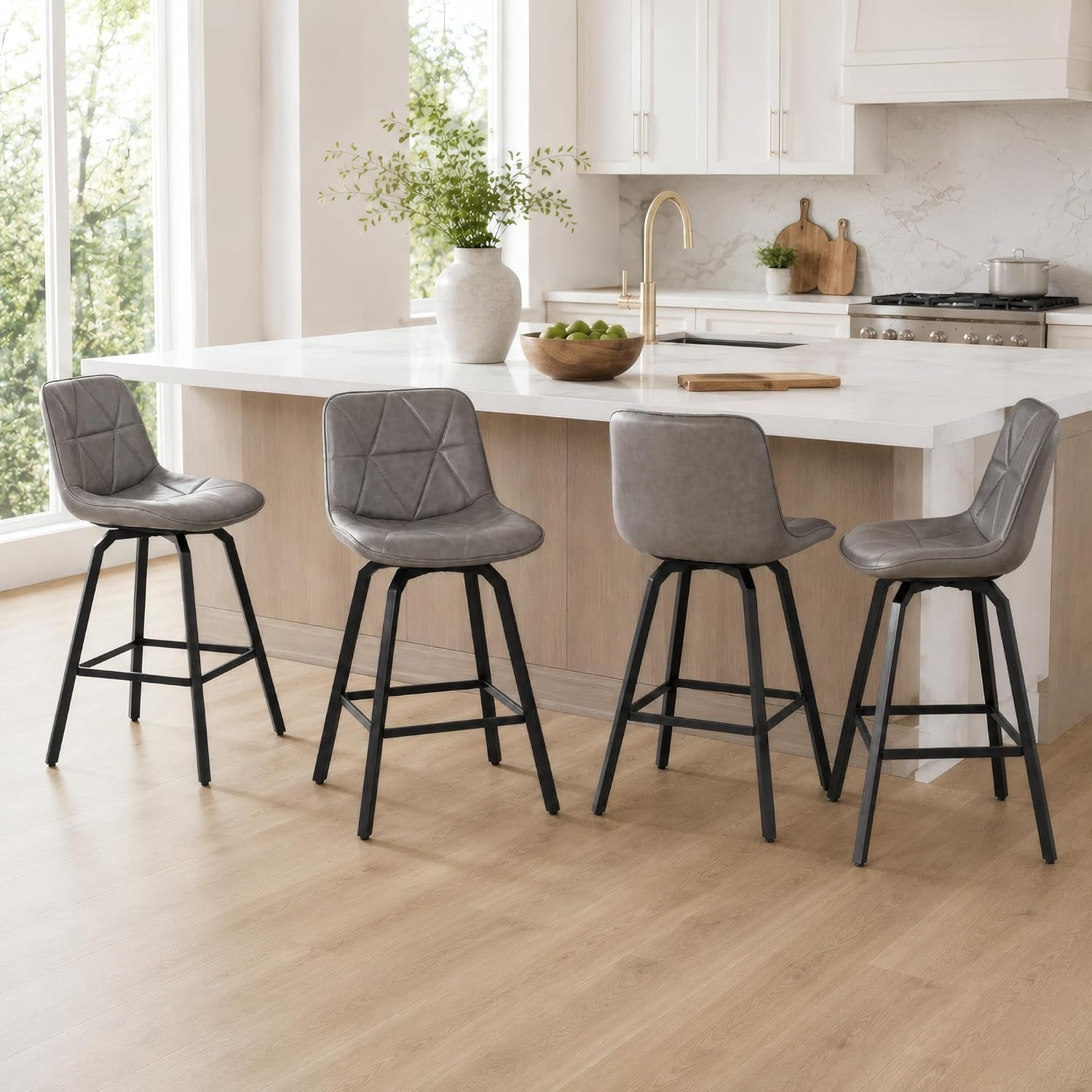 Four gray counter stools arranged along a kitchen island, two front-facing and two back-facing