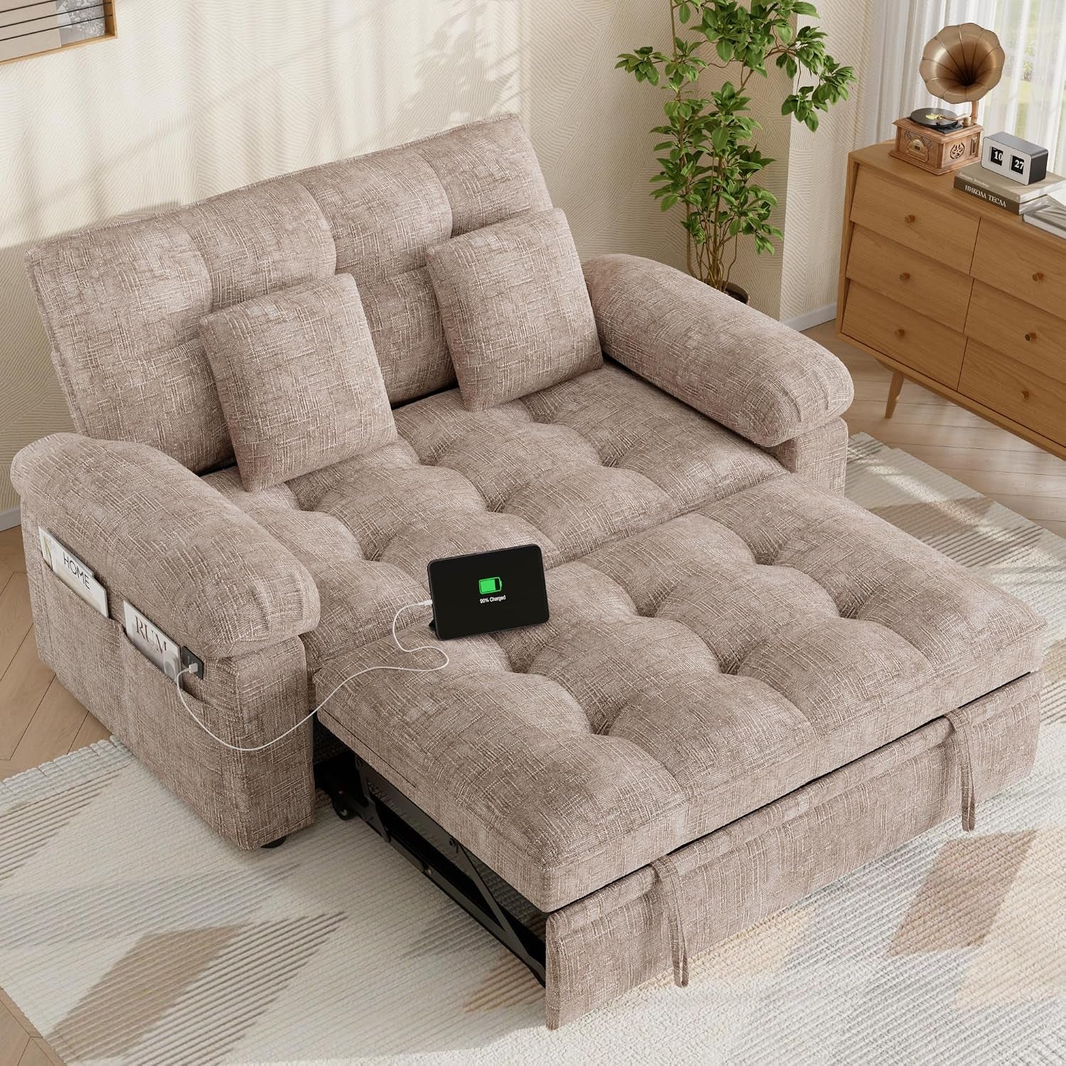 Khaki chenille loveseat sleeper sofa pulled out into bed with tablet charging on the surface and side pocket visible