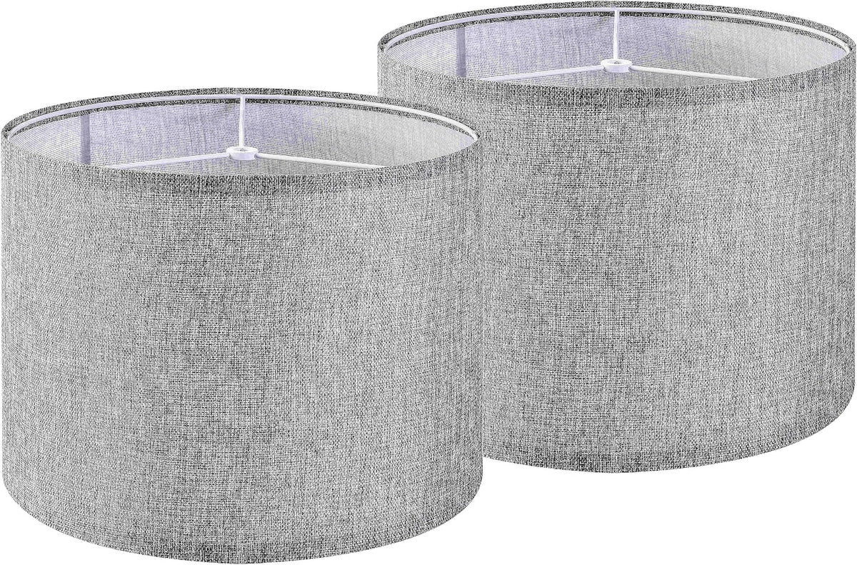 Two light gray textured linen drum lampshades overlapping, tops and internal frame visible.