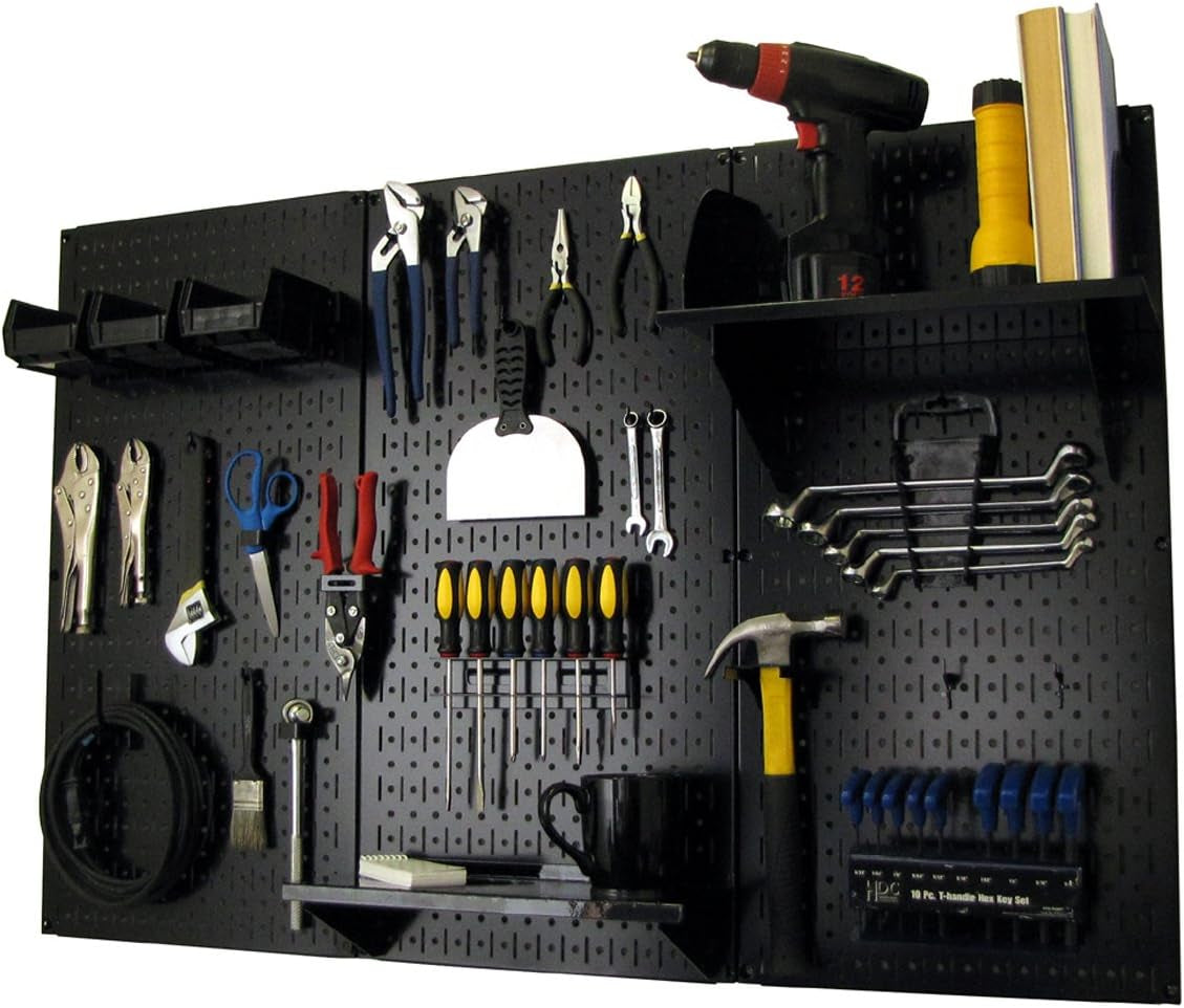 Black metal pegboard mounted on wall with assorted hand tools, shelves and bins organized across it.