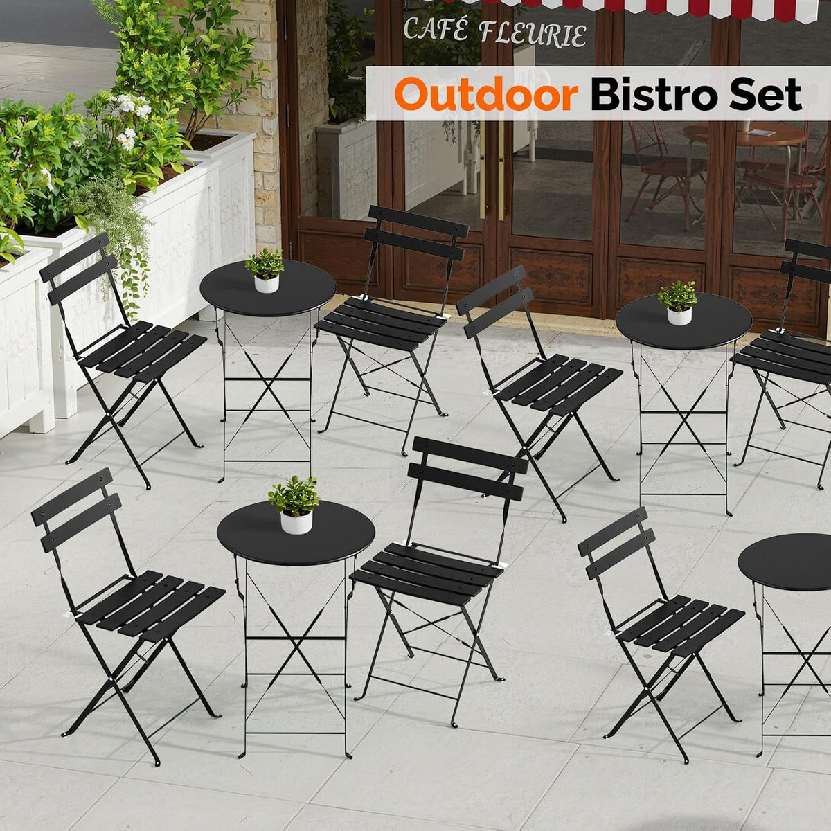 Multiple black bistro tables and chairs arranged on a tiled café patio with potted plants.